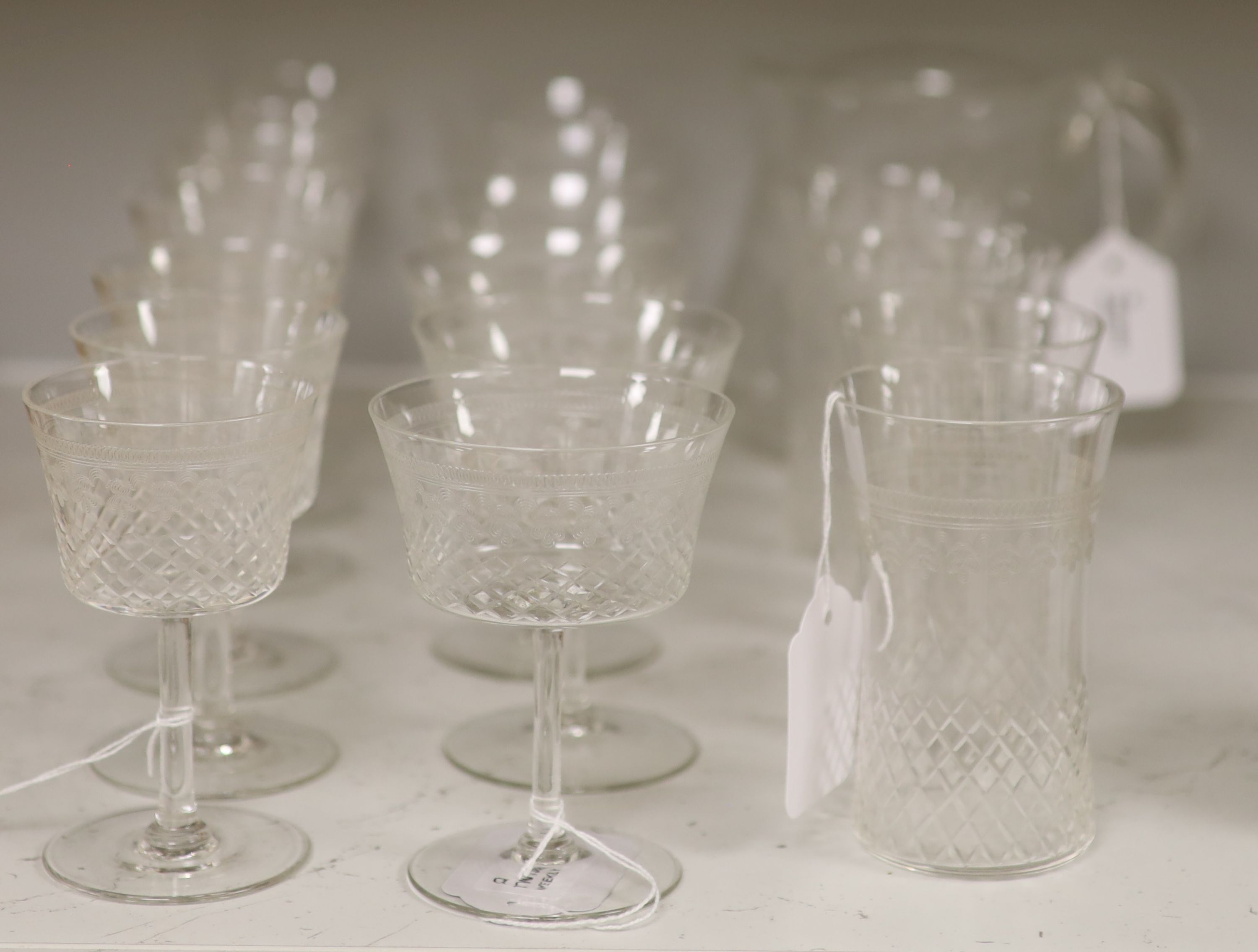 A part suite of 1930's table glass, comprising a water jug, four tumblers, six red wines and seven white wine glasses,